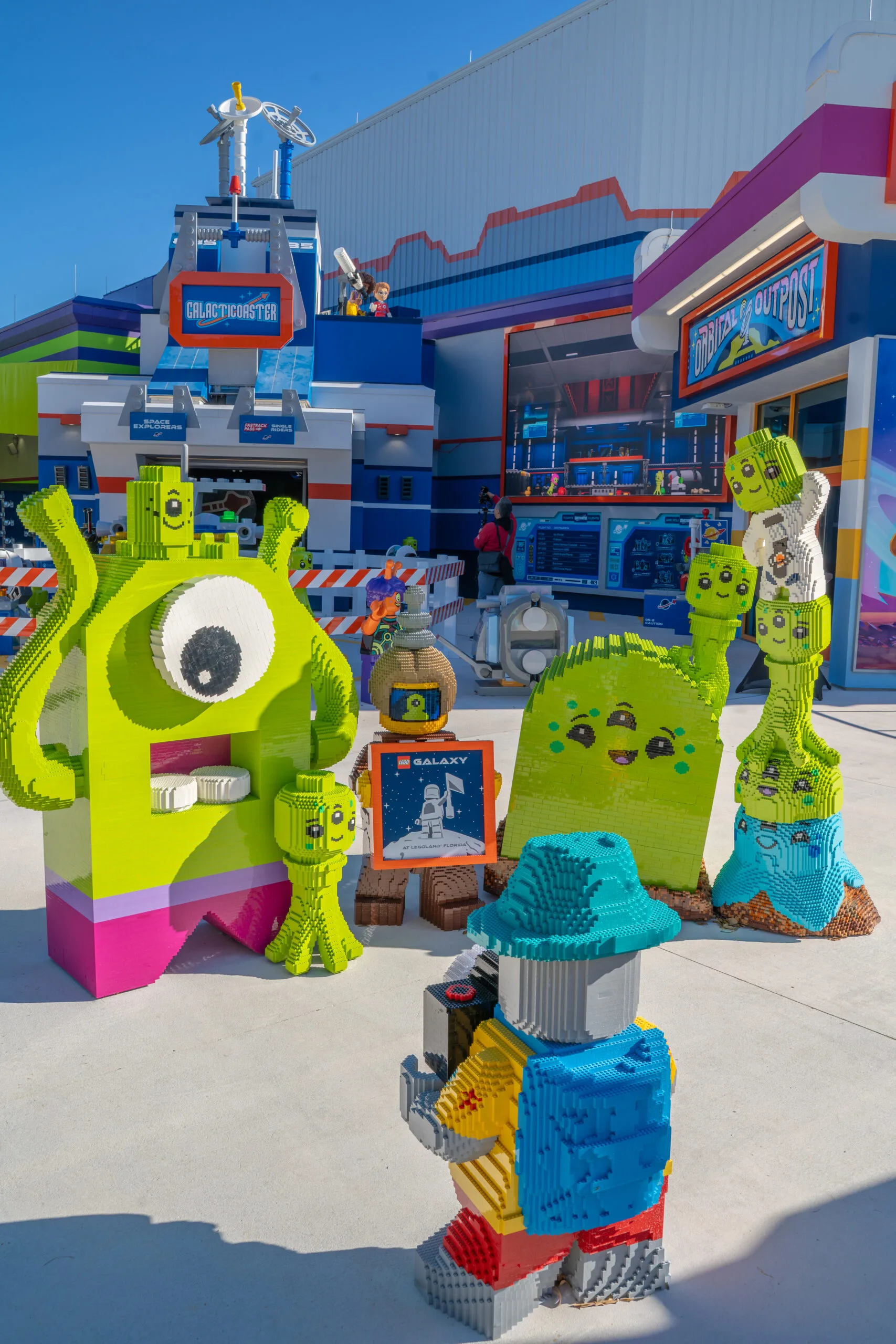 LEGO space-themed aliens in front of Galacticoaster at LEGOLAND Florida Resort.