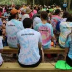 YMCA Camp Counselors seated on benches