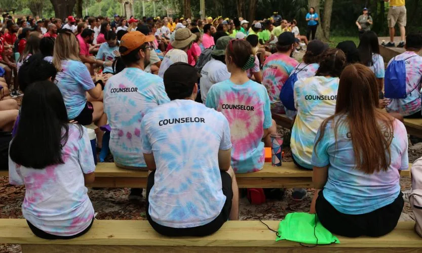 YMCA Camp Counselors seated on benches