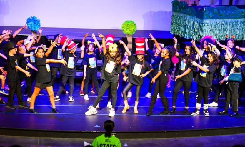 A group of young kids on stage performing Seussical at Corbett Prep