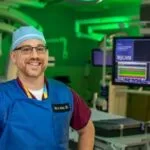 An image of a man standing inside a cath lab at John's Hopkins All Children's Hospital