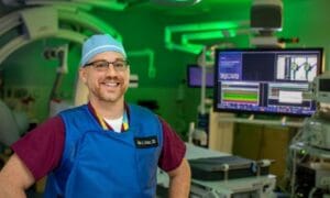 An image of a man standing inside a cath lab at John's Hopkins All Children's Hospital