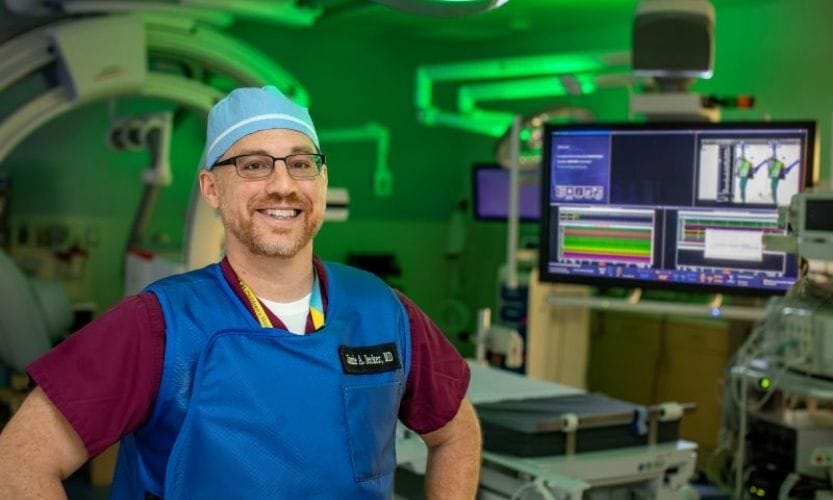An image of a man standing inside a cath lab at John's Hopkins All Children's Hospital
