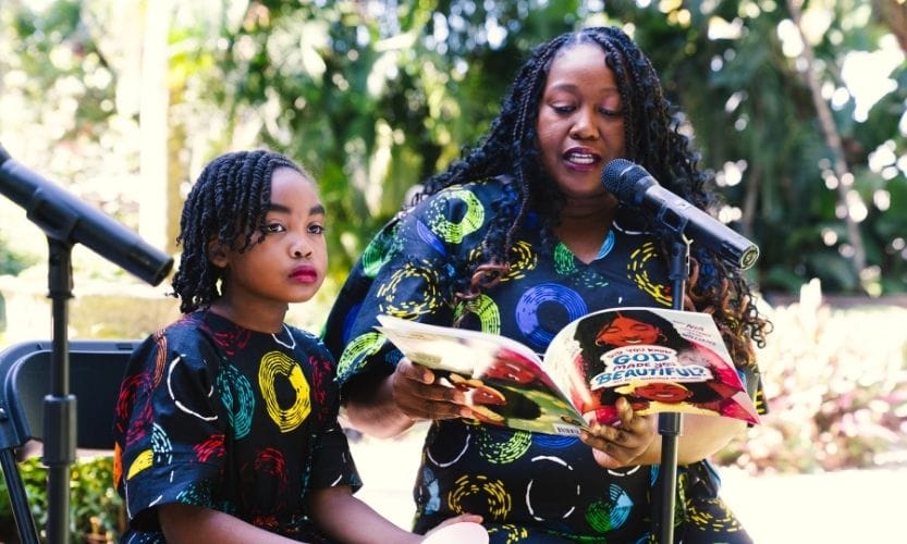 Nia Williams and her mom, Kiva Williams reading out loud to a group