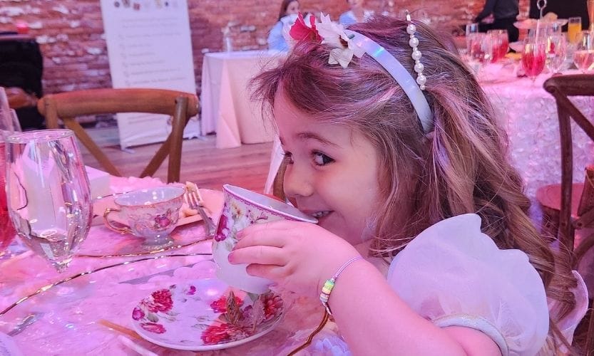 Little girl sipping tea at Mommy and Me High Tea!