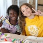 Two young girls enjoying their time at a YMCA camp