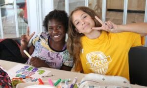 Two young girls enjoying their time at a YMCA camp