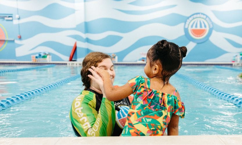 A young swimmer learning water safety at Watermelon Swim