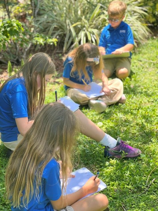 Students writing in notebooks outside at The dePaul School for Dyslexia