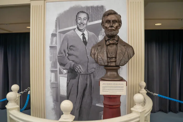 Painting of Walt Disney and a bust of Abraham Lincoln. Learn about American History at Liberty Square at Disney's Magic Kingdom
