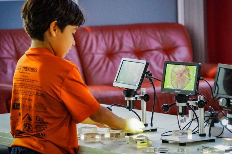 MOSI student playing with robots
