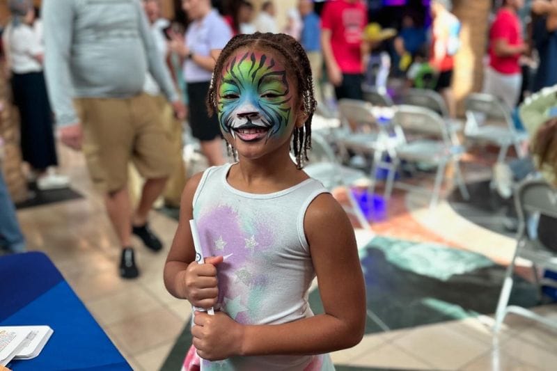 having fun with face paint at the back-to-school fair