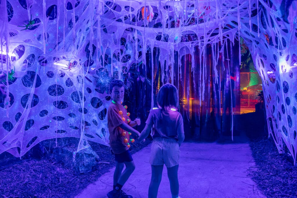 ZooTampa Creatures of the Night Kids at Scared of the Dark Kids walking under spide webs