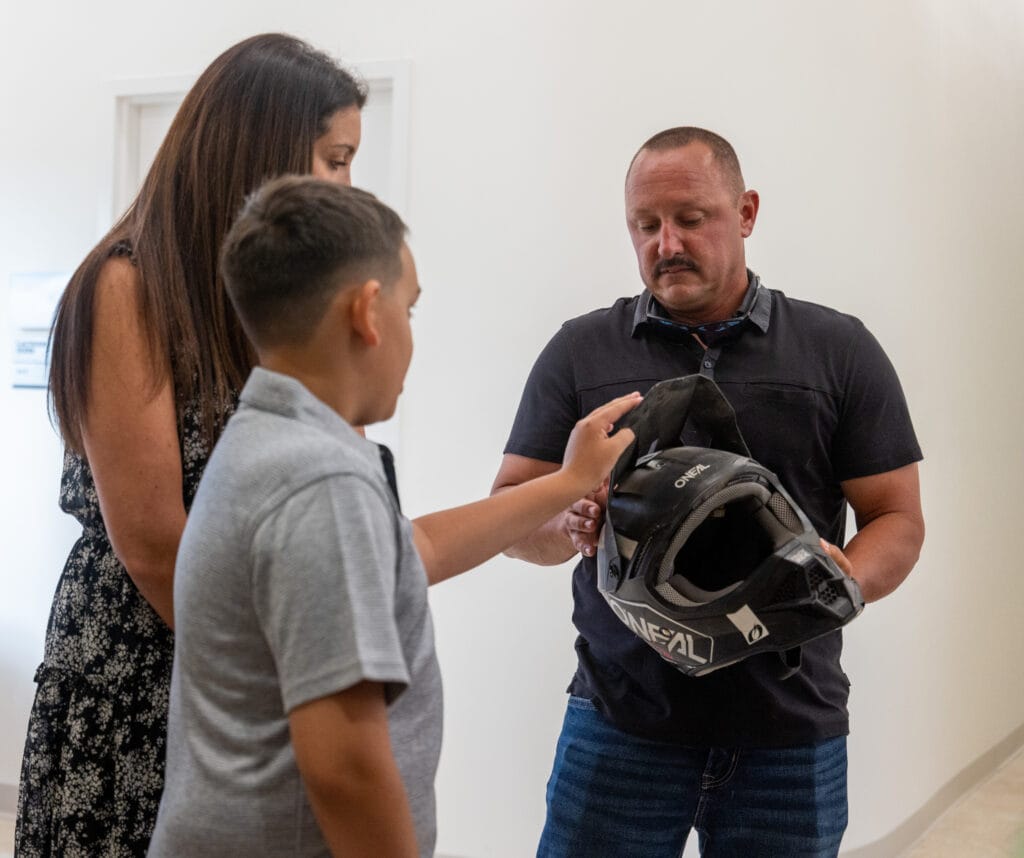 AAA E-Ride Safety Campaign. Dylan and his dad with the helmet that saved his life.