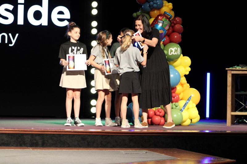 Mrs. Pitt, handing out a medal on stage at Countryside Christian Academy in Tampa