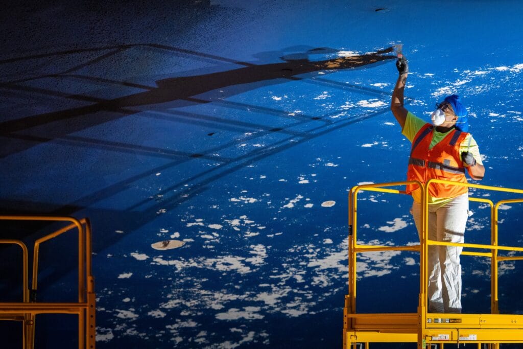 Tampa Theatre working scraping plaster ceiling to repaint during restoration project