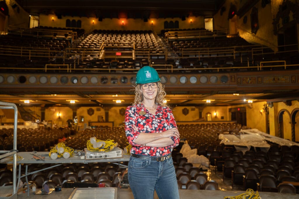 Jill Witecki with the Tampa Theatre stands on stage in the historic Duncan Auditorium. Photo by Laura Byrne.